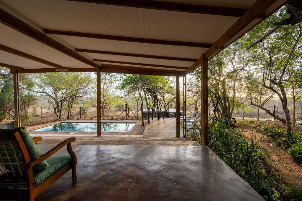 Shaded veranda overlooking the pool and bush at Tumbeta House